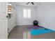 Spare room with exercise equipment, light gray walls, a ceiling fan, and a window with blinds at 10909 W Chase Ln, Avondale, AZ 85323