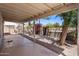 Covered patio with view of the backyard featuring desert landscaping, a privacy wall, and vegetation at 11049 N 111Th Way, Scottsdale, AZ 85259