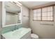Bathroom featuring light green sink and hardware and tiled shower and tub at 11049 N 111Th Way, Scottsdale, AZ 85259