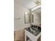 Modern bathroom with a black granite countertop, decorative mirror, and neutral wall colors at 11049 N 111Th Way, Scottsdale, AZ 85259