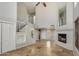 Open floor plan with tiled floors, a fireplace, and an open staircase with white railings at 11049 N 111Th Way, Scottsdale, AZ 85259