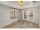 Neutral living room with tile floors, french doors to a private backyard area, and modern blinds at 11049 N 111Th Way, Scottsdale, AZ 85259