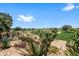 Scenic backyard view with desert landscaping, and neighborhood pond in background at 11553 W Cottontail Ct, Surprise, AZ 85378