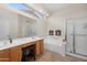 Well-lit bathroom with dual sinks, a soaking tub, and a separate shower, offering a spa-like experience at 11553 W Cottontail Ct, Surprise, AZ 85378