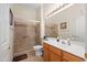 Modern bathroom featuring a glass-enclosed shower, oak cabinets, and ample counter space at 11553 W Cottontail Ct, Surprise, AZ 85378