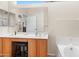 Bright bathroom with double sinks, a large mirror, and a soaking tub, perfect for relaxation at 11553 W Cottontail Ct, Surprise, AZ 85378