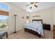 Comfortable bedroom with blue bedding, complemented by natural light and cozy carpeting at 11553 W Cottontail Ct, Surprise, AZ 85378