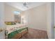 Cozy bedroom with carpet, ceiling fan, and a bed with decorative pillows at 11553 W Cottontail Ct, Surprise, AZ 85378
