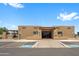 Exterior view of the Coyote Lakes Recreation Club featuring covered entrances and ample parking at 11553 W Cottontail Ct, Surprise, AZ 85378
