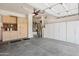 Spacious garage with storage cabinets, a modern door mechanism, and room for multiple vehicles at 11553 W Cottontail Ct, Surprise, AZ 85378