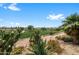 Scenic golf course view featuring desert vegetation and lush green landscape under a blue sky at 11553 W Cottontail Ct, Surprise, AZ 85378