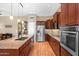 Modern kitchen with stainless steel appliances, granite countertops, and wood cabinets at 11553 W Cottontail Ct, Surprise, AZ 85378