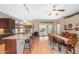 Bright and modern kitchen features granite counters and eat-in bar with wood cabinets at 11553 W Cottontail Ct, Surprise, AZ 85378