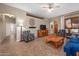 Open living room with high ceilings, and ceiling fan at 11553 W Cottontail Ct, Surprise, AZ 85378