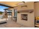 Outdoor fireplace, bench, and privacy gate to community pool at 11553 W Cottontail Ct, Surprise, AZ 85378