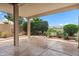 Stamped concrete patio featuring a lush landscape of plants and trees and overlooking a water feature at 11553 W Cottontail Ct, Surprise, AZ 85378