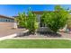 Lush backyard featuring artificial grass, desert landscaping, and patio at 12083 W Peak View Rd, Peoria, AZ 85383