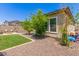 Low maintenance backyard with artificial grass, desert landscaping, and plenty of space for outdoor enjoyment at 12083 W Peak View Rd, Peoria, AZ 85383