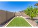 Private backyard with artificial grass and desert landscaping, perfect for relaxation and entertaining at 12083 W Peak View Rd, Peoria, AZ 85383