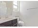 Bright bathroom featuring a modern vanity, shower, and toilet, offering a clean and functional space at 12083 W Peak View Rd, Peoria, AZ 85383