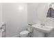 Powder room featuring a pedestal sink, modern fixtures, and neutral decor at 12083 W Peak View Rd, Peoria, AZ 85383