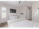 Bright bedroom with a ceiling fan, modern dresser, and neutral decor at 12083 W Peak View Rd, Peoria, AZ 85383
