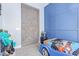 Stylish bedroom featuring a unique barn door and custom wall paneling, adding character and charm at 12083 W Peak View Rd, Peoria, AZ 85383