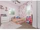 Charming bedroom featuring stylish wallpaper, shutters, a cozy bed, and ample space for play and relaxation at 12083 W Peak View Rd, Peoria, AZ 85383