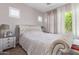 Cozy bedroom with shuttered windows, soft lighting, and comfortable furnishings at 12083 W Peak View Rd, Peoria, AZ 85383