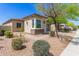 Charming single-story home featuring desert landscaping and a modern garage door at 12083 W Peak View Rd, Peoria, AZ 85383
