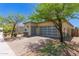 Home showcasing a modern garage door, desert landscaping, and charming exterior at 12083 W Peak View Rd, Peoria, AZ 85383
