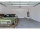 Spacious garage featuring epoxy flooring, ample space for parking, and a water heater, offering functionality and convenience at 12083 W Peak View Rd, Peoria, AZ 85383