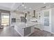 Bright kitchen features white cabinets, stainless steel appliances, and a spacious island with granite countertops at 12083 W Peak View Rd, Peoria, AZ 85383