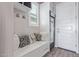 Organized mud room with bench seating, storage cabinets, and a beverage refrigerator at 12083 W Peak View Rd, Peoria, AZ 85383