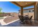 Covered patio with outdoor seating and a fire pit area, perfect for entertaining and relaxing in the backyard at 12083 W Peak View Rd, Peoria, AZ 85383