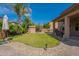 A spacious backyard showcases a lush lawn, rock landscaping, and a covered patio for outdoor enjoyment at 12238 W Patrick Ct, Sun City, AZ 85373