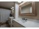 Bathroom features double sinks, decorative mirror, and modern lighting at 12238 W Patrick Ct, Sun City, AZ 85373