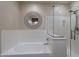 Bathroom showcasing a soaking tub and glass-enclosed shower at 12238 W Patrick Ct, Sun City, AZ 85373