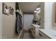 Bathroom showcasing double sinks, stylish lighting, and decorative wall accents at 12238 W Patrick Ct, Sun City, AZ 85373