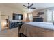 Bedroom featuring a large mounted TV and decorative shelves and dresser at 12238 W Patrick Ct, Sun City, AZ 85373