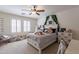 Delightful bedroom featuring plush bedding, ample natural light, and cozy decor, creating a comforting retreat at 12238 W Patrick Ct, Sun City, AZ 85373