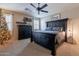 Cozy bedroom with a large bed, ceiling fan and window shutters at 12238 W Patrick Ct, Sun City, AZ 85373