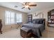Bedroom with ceiling fan, trunk, and natural light from windows at 12238 W Patrick Ct, Sun City, AZ 85373