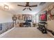 Expansive bonus room with a functional desk setup, complemented by natural light and workout equipment at 12238 W Patrick Ct, Sun City, AZ 85373