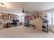 Spacious bonus room featuring a work area and lounge space with mounted deer heads, creating a versatile environment at 12238 W Patrick Ct, Sun City, AZ 85373