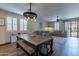 Open dining area with a rustic table and views of the living room; great for entertaining at 12238 W Patrick Ct, Sun City, AZ 85373