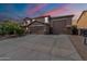 Beautiful two-story home with a three-car garage and well-manicured front yard at 12238 W Patrick Ct, Sun City, AZ 85373