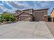 Inviting two-story home with a three-car garage and a spacious driveway at 12238 W Patrick Ct, Sun City, AZ 85373