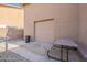 Picnic table and trash can are next to the garage door in the back yard at 12238 W Patrick Ct, Sun City, AZ 85373