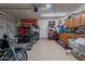 A well-equipped garage with cabinets, tool storage, and space for multiple motorcycles at 12238 W Patrick Ct, Sun City, AZ 85373